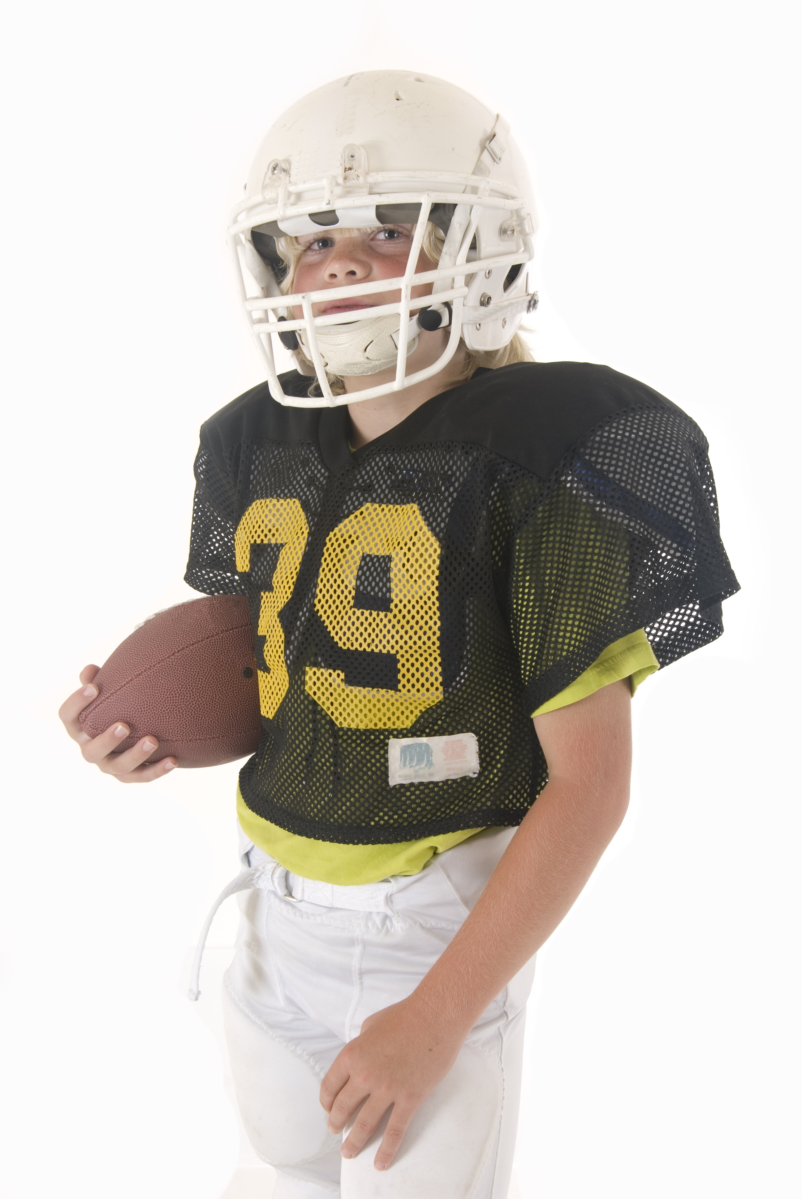 Boy fullback holding American football in uniform